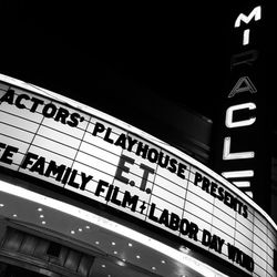 Low angle view of information sign at night