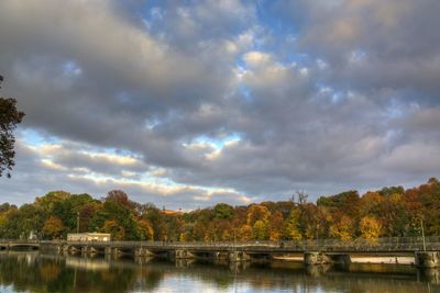 Scenic view of lake by trees against sky