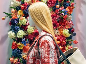 Close-up of mannequin against flowers