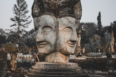 Statue of buddha against trees