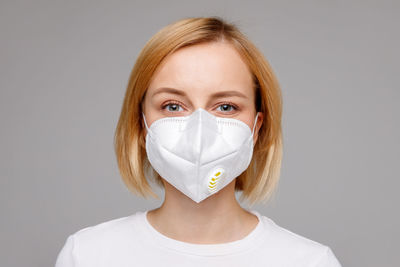 Portrait of beautiful young woman over white background