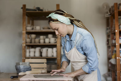 Potter working in art studio