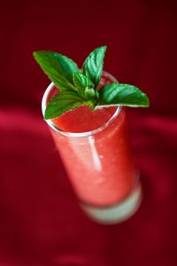 Close-up of drink on red leaf