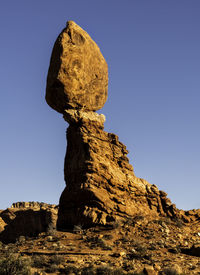 Low angle view of rock formation against blue sky