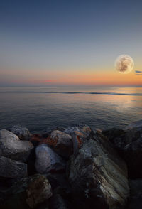 Scenic view of sea against sky at sunset
