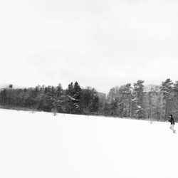 Scenic view of snow covered field against sky
