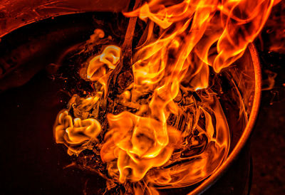 Close-up of fire in the dark making an axe in the forge