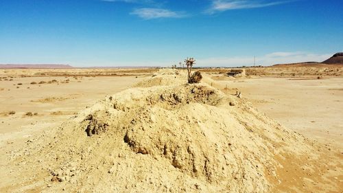 Sand dune in desert against clear sky