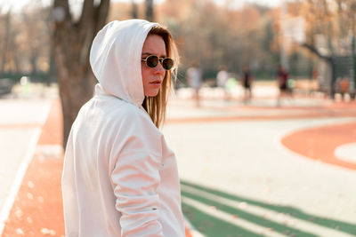 Portrait of woman wearing sunglasses standing outdoors