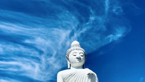 Low angle view of statue against blue sky