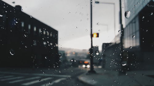 Close-up of wet glass window in rainy season