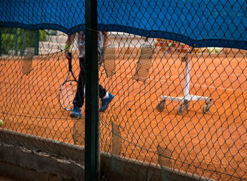 Low section of man with racket playing on field