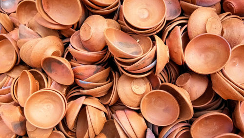 Close up of heap of indian clay oil lanterns or diya ready to be sold in market during diwali 