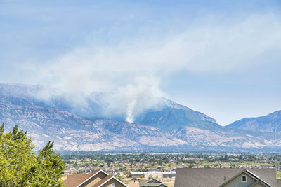 Panoramic view of buildings and mountains against sky