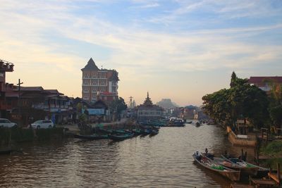 Boats in canal amidst buildings in city