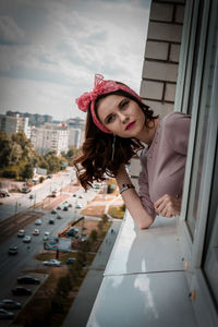 Portrait of young woman standing in city