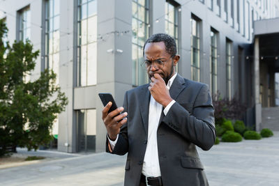 Young businessman using mobile phone