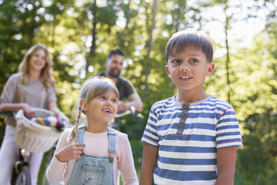 Portrait of smiling friends standing in park