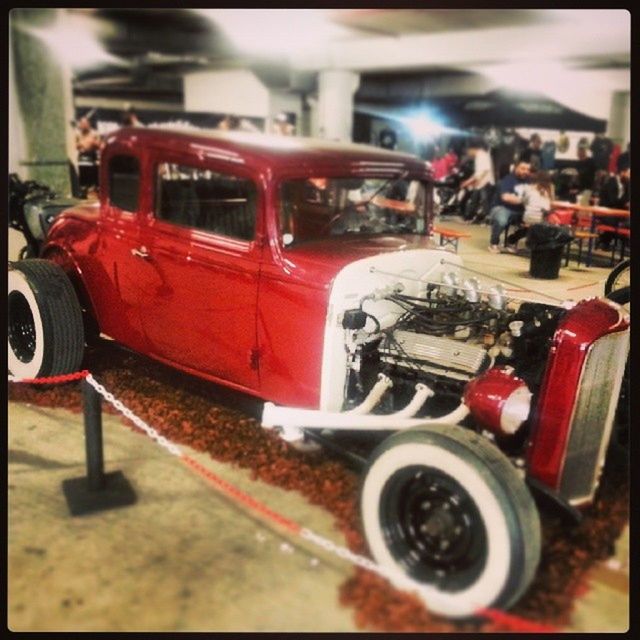 transportation, land vehicle, mode of transport, transfer print, red, car, auto post production filter, close-up, selective focus, focus on foreground, travel, stationary, incidental people, street, day, vintage car, outdoors, no people, metal, steering wheel