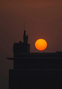 Low angle view of building against sky during sunset