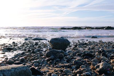 Scenic view of rocky beach against sky