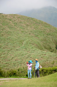 Full length of girl standing on grassy field