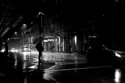 Man in illuminated city at night