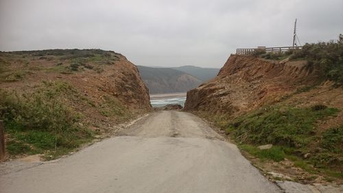 Road amidst mountains against sky