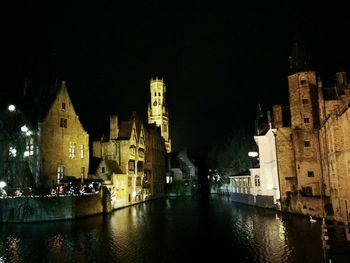 Illuminated buildings with waterfront at night