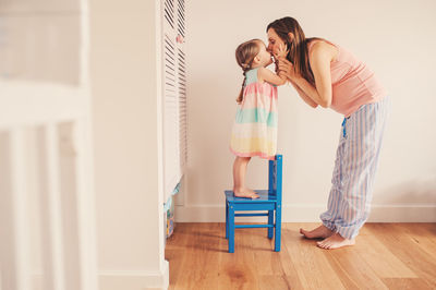 Mother and daughter on floor at home