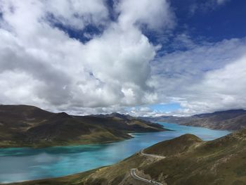 Scenic view of sea and mountains against sky