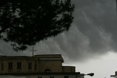 Low angle view of building against cloudy sky