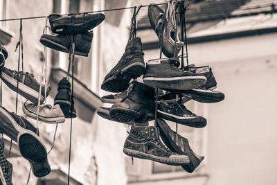 Low angle view of shoes hanging on metal