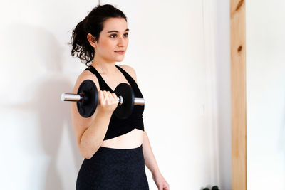 Young woman exercising in gym