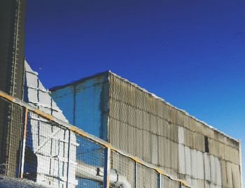 Low angle view of modern building against blue sky