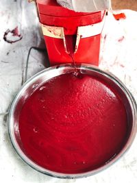 High angle view of red wine in glass on table