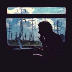 Woman looking through window