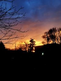 Silhouette trees against sky during sunset