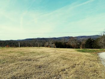 Scenic view of farm against sky