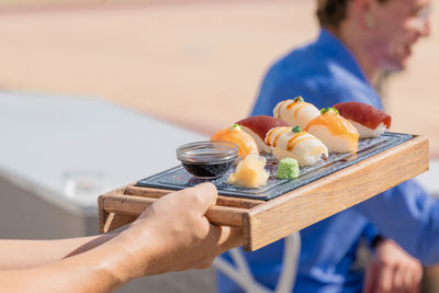 Midsection of people holding ice cream on table