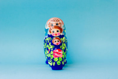 Close-up of toys on table against blue background