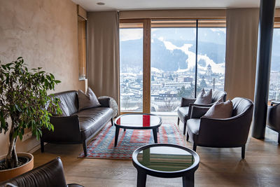 Interior of stylish lobby with view of townscape at luxurious ski resort