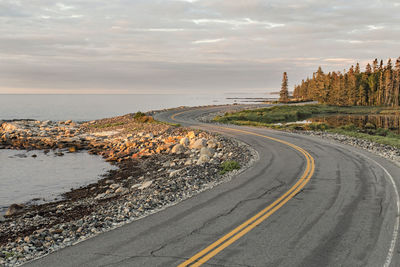 Twisting road winds along maine coast at sunrise, acadia national park