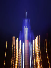 Panoramic view of illuminated buildings against sky at night