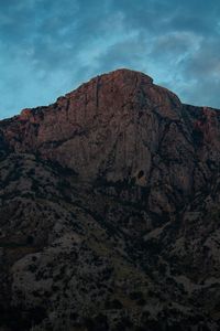 Low angle view of rocky mountains against sky