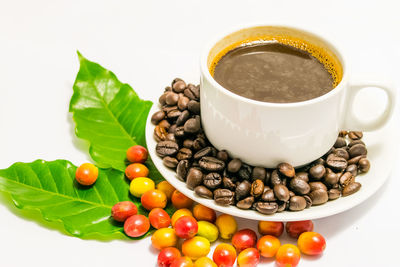 High angle view of coffee beans against white background