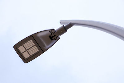 Low angle view of telephone pole against white background