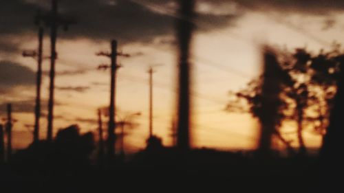 Silhouette trees against sky at sunset