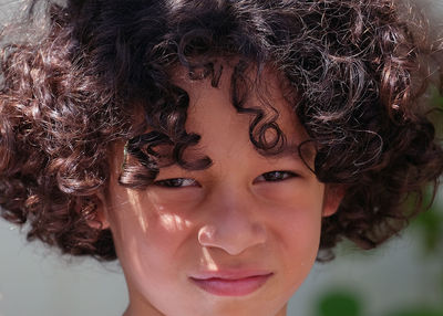 Boy with lots of curly hair.