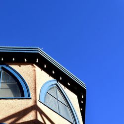 Low angle view of built structure against blue sky